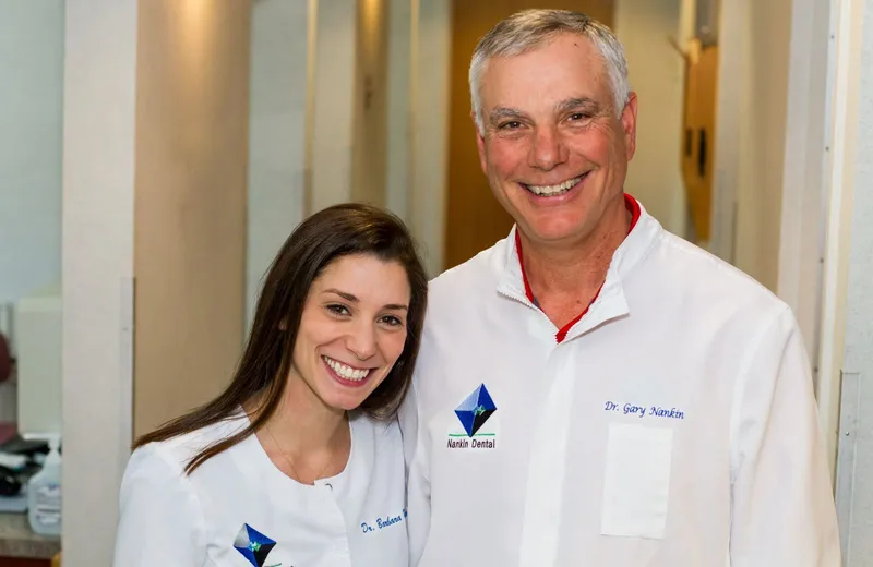 Dr. Barbara Nankin and Dr. Gary Nankin smiling in the office